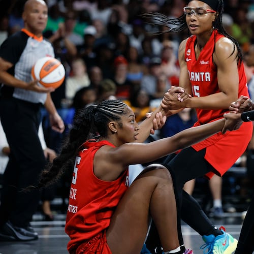 Dream guards Allisha Gray (center) and Jordin Canada help forward Angel Reese up during their game against the Minnesota Lynx at Gateway Center Arena on Sunday, Aug. 30, 2026, in Atlanta. Reese says she and her team are “going to go all the way.” (Miguel Martinez/AJC)