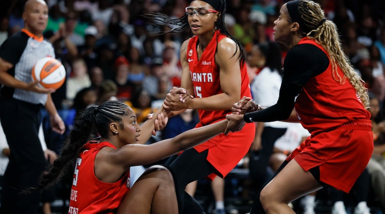 Dream guards Allisha Gray (center) and Jordin Canada help forward Angel Reese up during their game against the Minnesota Lynx at Gateway Center Arena on Sunday, Aug. 30, 2026, in Atlanta. Reese says she and her team are “going to go all the way.” (Miguel Martinez/AJC)