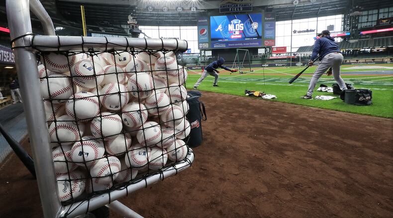 Atlanta Braves second baseman Ozzie Albies takes ground balls from third base coach Ron Washington during team practice at American Family Field preparing for the opening game of the National League Division Series against the Milwaukee Brewers on Thursday, Oct. 7, 2021, in Milwaukee. Curtis Compton / Curtis.Compton@ajc.com