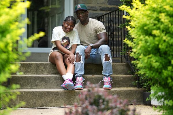 Evan Polk and his daughter, Jordyn Polk, 13, sit for a portrait in Secane, Pa., Thursday, June 5, 2025. (AP Photo/Matt Slocum)
