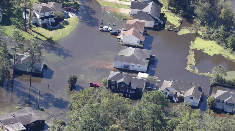 Flood waters receed from around houses of a Savannah neighborhood in the aftermath of Hurricane Matthew on Sunday, Oct. 9, 2016. Curtis Compton /ccompton@ajc.com