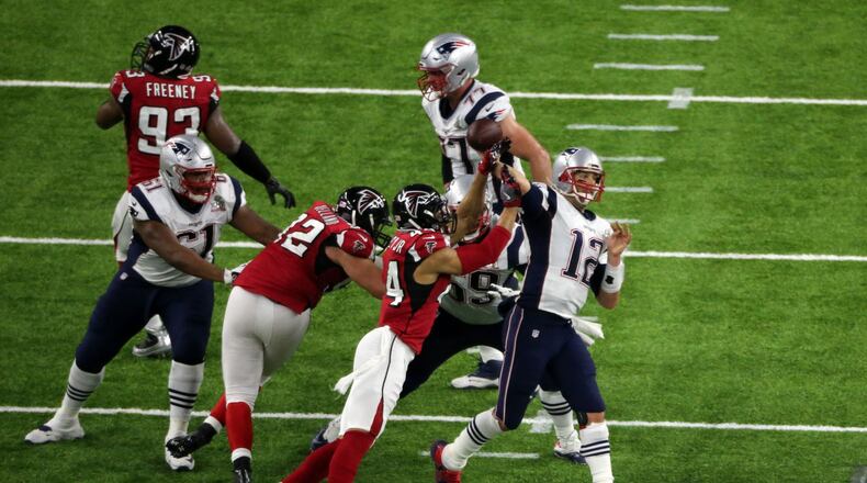 Atlanta Falcons outside linebacker Vic Beasley (44) hits New England Patriots quarterback Tom Brady (12) as he passes in the 2nd quarter Sunday. John Spink/AJC