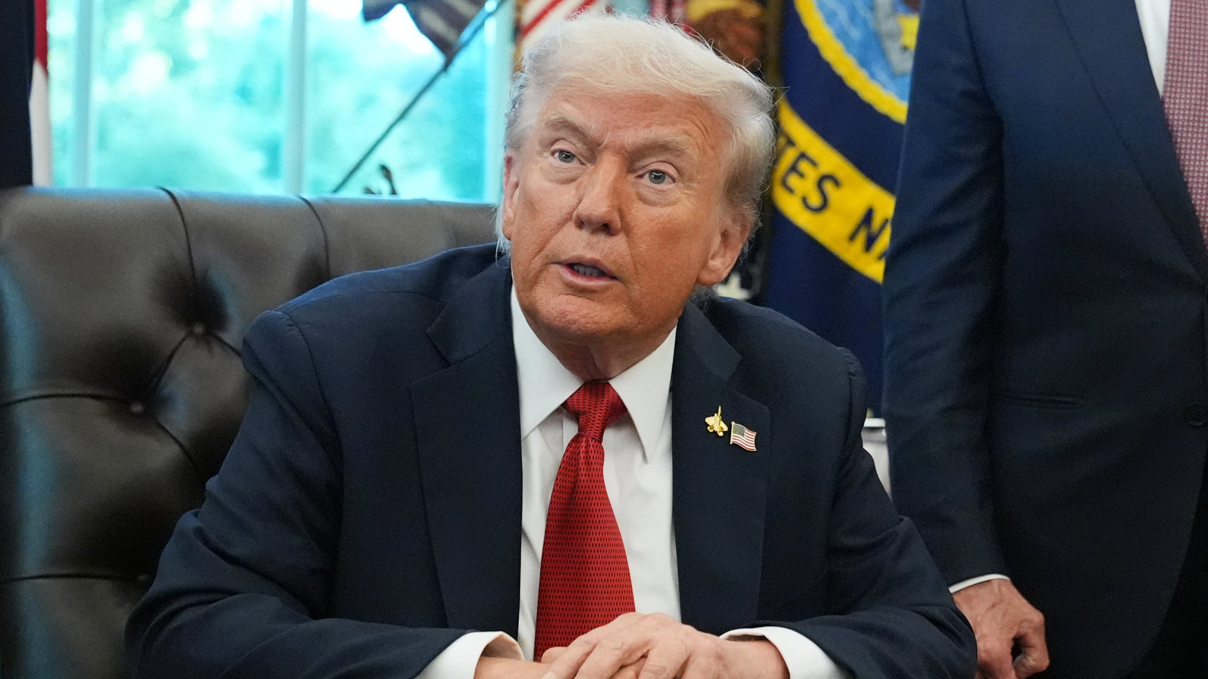 President Donald Trump speaks to reporters before signing an executive order in the Oval Office at the White House, Monday, Oct. 6, 2025, in Washington. (AP Photo/Jacquelyn Martin)