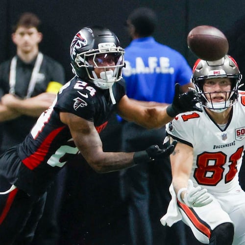 Atlanta Falcons cornerback A.J. Terrell Jr. (left) fights for the ball as Tampa Bay Buccaneers wide receiver Ryan Miller watches during the second half of an NFL game at Mercedes-Benz Stadium on Sunday, Sept. 7, 2025, in Atlanta. (Miguel Martinez/AJC)