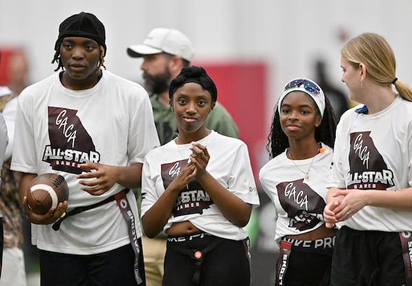 From left, Morgan Jordan and Courtney Emmons, both from Luella, and Locust Grove's Rayna Brown line up for introductions before the GACA Girls Flag Football All-Star Game at the Atlanta Falcons' indoor facility on Saturday, Feb. 21, 2026, in Flowery Branch. (Hyosub Shin/AJC)