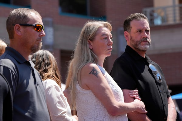 Karen and Scott Laramie, the mother and stepfather of Madison Mogen, listen as their attorney Leander James makes a statement to members of the media outside the Ada County Courthouse on Wednesday, July 2, 2025, in Boise, Idaho. (AP Photo/Jenny Kane)