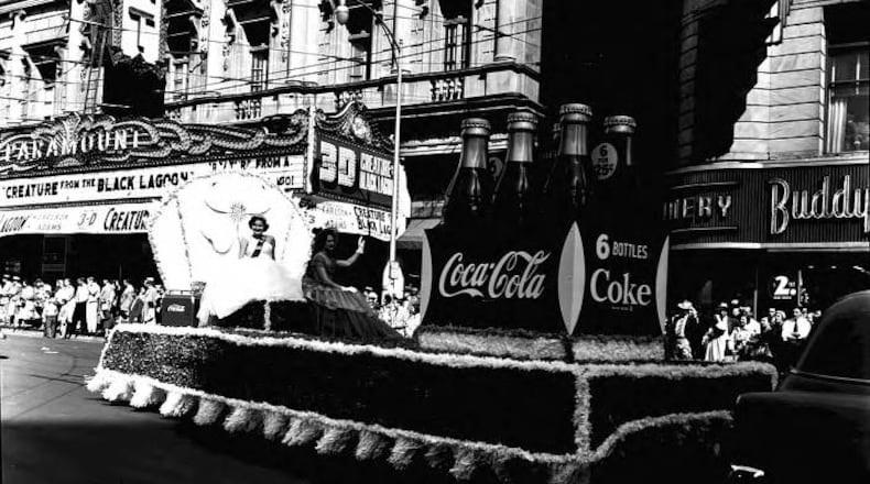March, 17, 1954 -- The Coca-Cola float makes its way past the Paramount Theatre in downtown Atlanta as part of the city's annual St. Patrick's Day parade. LANE BROS. PHOTOGRAPHIC COLLECTION / GSU