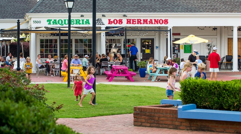 Dunwoody Village businesses, including Taqueria Los Hermonos in The Shops of Dunwoody strip mall, may soon have a new city center, in the mean time the locals enjoy whatever green space and outdoor patios they can find in the multiple shopping complexes, patched together in the area on Thursday, July 22, 2021.  (Jenni Girtman for The Atlanta Journal-Constitution)
