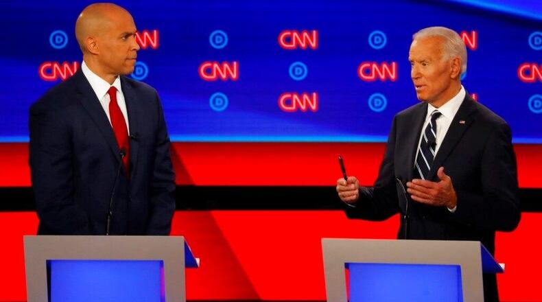 Sen. Cory Booker, D-N.J., listens as former Vice President Joe Biden speaks during the second of two Democratic presidential primary debates hosted by CNN Wednesday, July 31, 2019, in the Fox Theatre in Detroit.