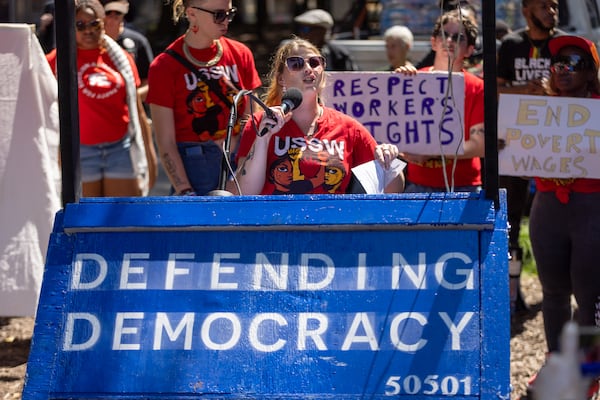A Waffle House employee and Union of Southern Service Workers member speaks at a Labor Day rally in Atlanta's Woodruff Park.