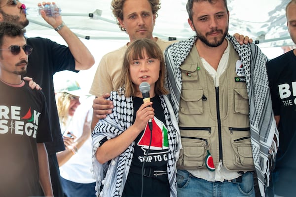Climate activist Greta Thunberg flanked by Thiago Avila from a human rights organization meets with journalists in Catania, Italy, Sunday, June 1, 2025, ahead of their departure for the Mideast. (AP Photo/Salvatore Cavalli)