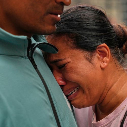 A relative consoles Sabina Dangal outside a government hospital as she waits for news of her brother, who is missing after flash floods, in Kathmandu, Nepal, Friday, Aug. 28, 2026. (AP Photo/Dar Yasin)