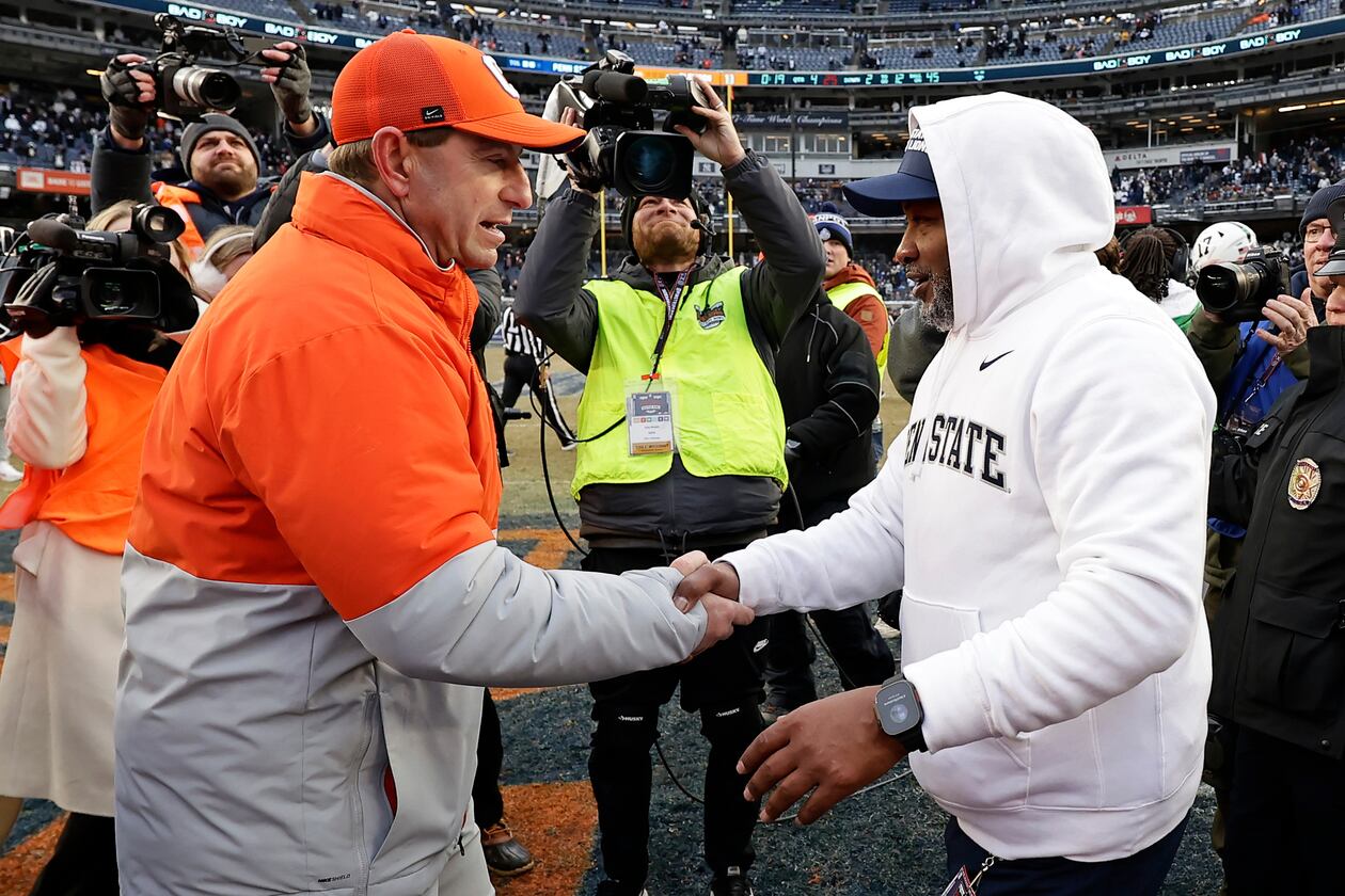 Penn State interim head coach Terry Smith, right, shakes ands with Clemson head coach Dabo Swinney after the Pinstripe Bowl NCAA college football game at Yankee Stadium, Saturday, Dec. 27, 2025, in New York. (AP Photo/Adam Hunger)
