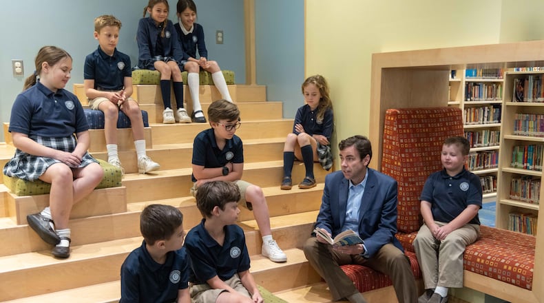 Cornerstone Academy Headmaster Colin Creel (second from right) reads to a class of students the library. For the Top Workplace small sized business. PHIL SKINNER FOR THE ATLANTA JOURNAL-CONSTITUTION