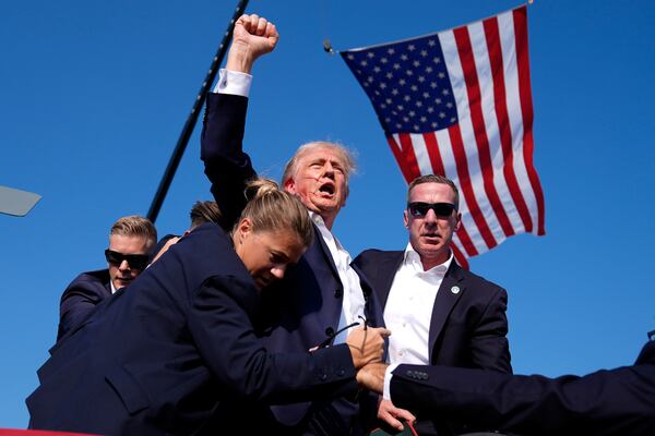 FILE - Republican presidential candidate former President Donald Trump is surrounded by U.S. Secret Service agents after an assassination attempt at a campaign rally in Butler, Pa., Saturday, July 13, 2024. (AP Photo/Evan Vucci, File)
