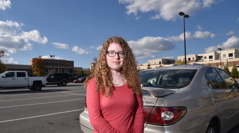 Sarah Saltzman stands in the AVALON Whole Foods market parking lot where her she had to pay $75 to get her car unbooted. HYOSUB SHIN / HSHIN@AJC.COM