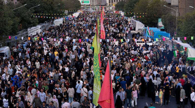 Crowds fill a street during celebrations marking Prophet Muhammad's birthday in Tehran, Iran, Sunday, Aug. 30, 2026. (AP Photo/Vahid Salemi)