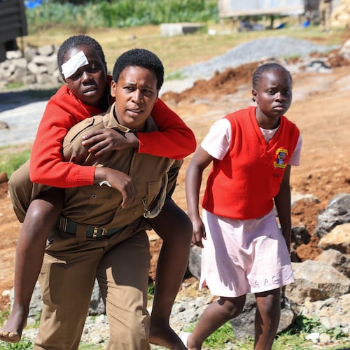 An injured student is evacuated following an early morning fire outbreak at Utumishi Girls School in the Gilgil area, central Kenya, Thursday, May 28, 2026. (AP Photo/Andrew Kasuku)