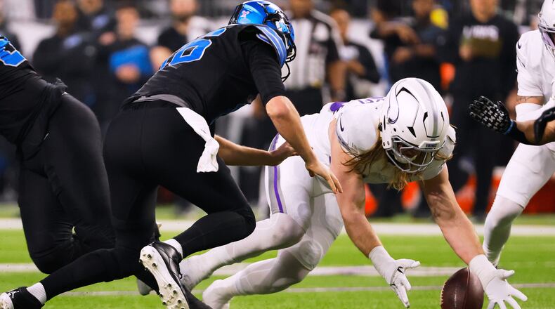 Minnesota Vikings linebacker Andrew van Ginkel, right, recovers a fumble by Detroit Lions quarterback Jared Goff, left, during the first half of an NFL football game, Thursday, Dec. 25, 2025, in Minneapolis. (AP Photo/Bruce Kluckhohn)