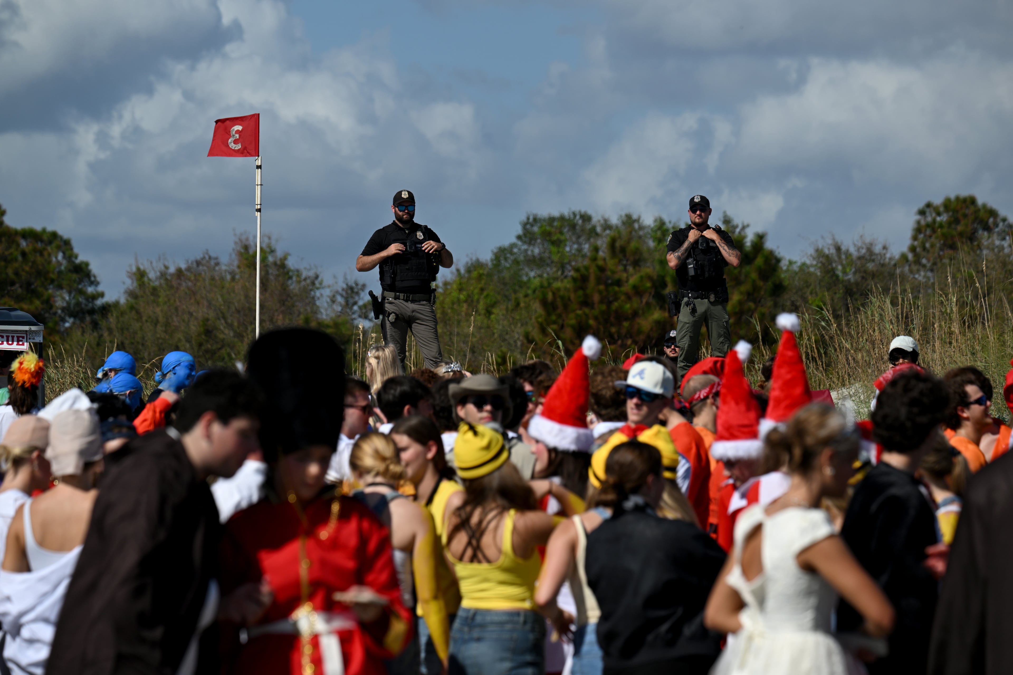 Local enforcement officers monitor during the annual “Frat Beach” party for the weekend of the Georgia-Florida football game on St. Simons Island, Friday, November 1, 2024. On the weekend of the Georgia-Florida football game, St. Simons Island’s East Beach becomes “Frat Beach,” an open-air party teeming with thousands of college students. (Hyosub Shin / AJC)