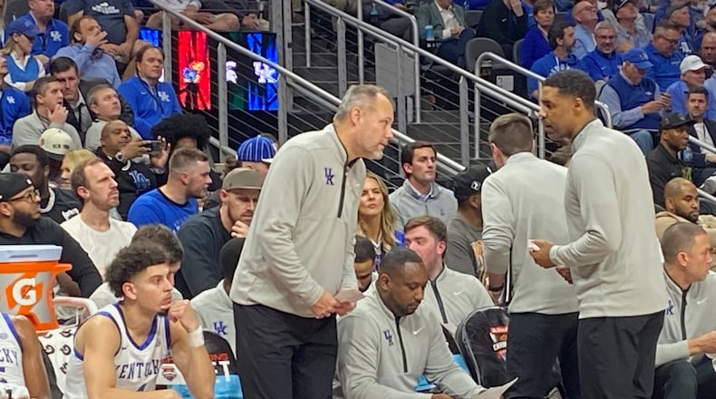 Kentucky assistant coach Mark Fox confers with fellow assistant Jason Hart during a game against Duke at State Farm Arena in the Champions Classic Nov. 12, 2024. Fox was previously head coach at Georgia 2009-2018. (AJC photo by Ken Sugiura)