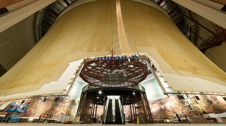 This photo shows an exterior view of the panoramic painting “The Battle of Atlanta” taken early in the restoration process. It reveals the hyperbolic shape of the painting when hung correctly. At the center is an escalator that will take visitors to the viewing platform. The diorama around the base of the painting had not yet been installed.CONTRIBUTED BY THE ATLANTA HISTORY CENTER