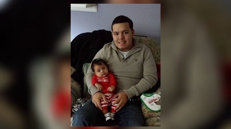 Daniel Perez, pictured with his son, died Monday after he was taken off life support. He was shot Friday night in Cobb County.