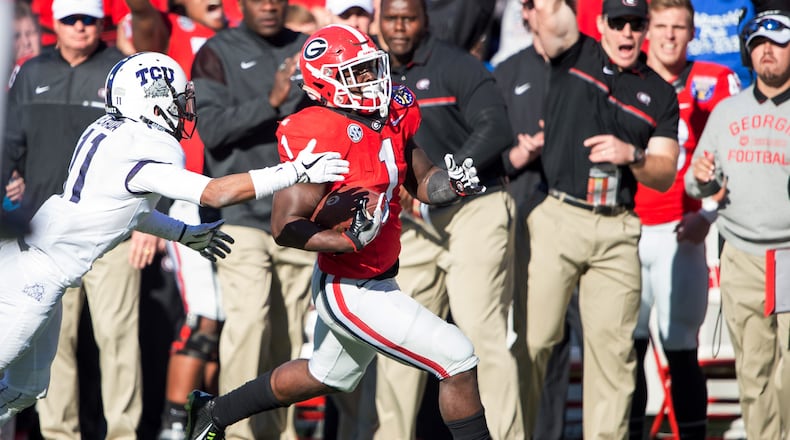 Georgia running back Sony Michel runs the ball past TCU cornerback Ranthony Texada in the Liberty Bowl. Michel rushed for 87 yards and scored a touchdown in the Bulldogs’ 31-23 win over the Horned Frogs. (Michael Chang/Getty Images)