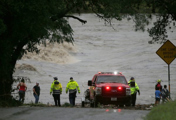 First responders scan the banks of the Guadalupe River for individuals swept away by flooding in Ingram, Texas, Thursday, July 4, 2025. (Michel Fortier/The San Antonio Express-News via AP)