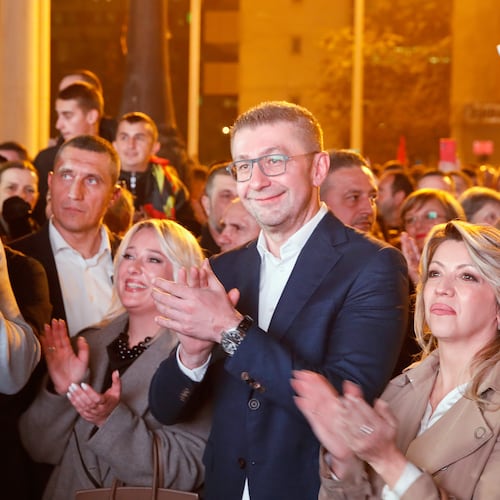 Hristijan Mickoski, center, the leader of the conservative VMRO-DPMNE party applauds in front of the party headquarters after announcing a "great" victory in the local elections, in Skopje, North Macedonia, on Sunday, Nov. 2, 2025. (AP Photo/Boris Grdanoski)