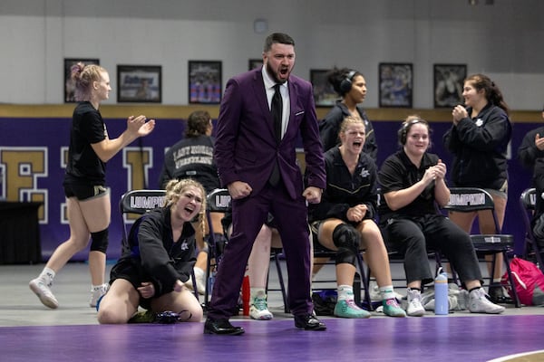 Scott Degraff, Lumpkin County High's girls wrestling coach, reacts after one of his wrestlers pins her opponent.