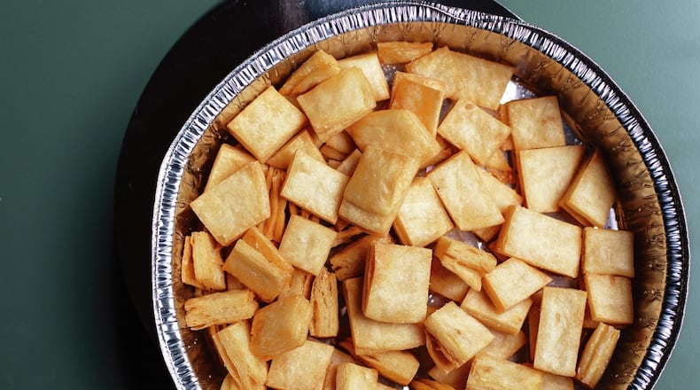 Tortilla Croutons are made by stacking flour tortillas, binding them with an egg wash, cutting them into squares and frying them in vegetable oil. This photograph is from “Turnip Greens & Tortillas” by Eddie Hernandez and Susan Puckett. Copyright © 2018 by Eddie Hernandez and Susan Puckett. Photography by Angie Mosier. Copyright © 2018 by Placemat Productions Inc. Used by permission of Houghton Mifflin Harcourt. All rights reserved.