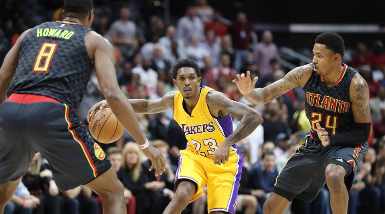 November 2, 2016, ATLANTA: Lakers Lou Williams drives against Hawks defenders Dwight Howard and Kent Bazemore during the fourth period in an NBA basketball game at Philips Arena on Wednesday, Nov. 2, 2016, in Atlanta. The Lakers beat the Hawks 123-116. Curtis Compton /ccompton@ajc.com