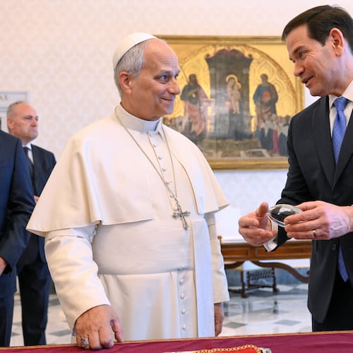 In this handout photo provided by Vatican Media Pope Leo XIV exchanges gifts with U.S. Secretary of State Marco Rubio, right, as they meet in the pope's private library at the Vatican, Thursday, May 7, 2026. (Vatican Media via AP)