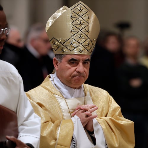 FILE - Mons. Angelo Becciu presides over an eucharistic liturgy at the St. John Lateran Basilica in Rome, Feb. 9, 2017. (AP Photo/Gregorio Borgia, File)