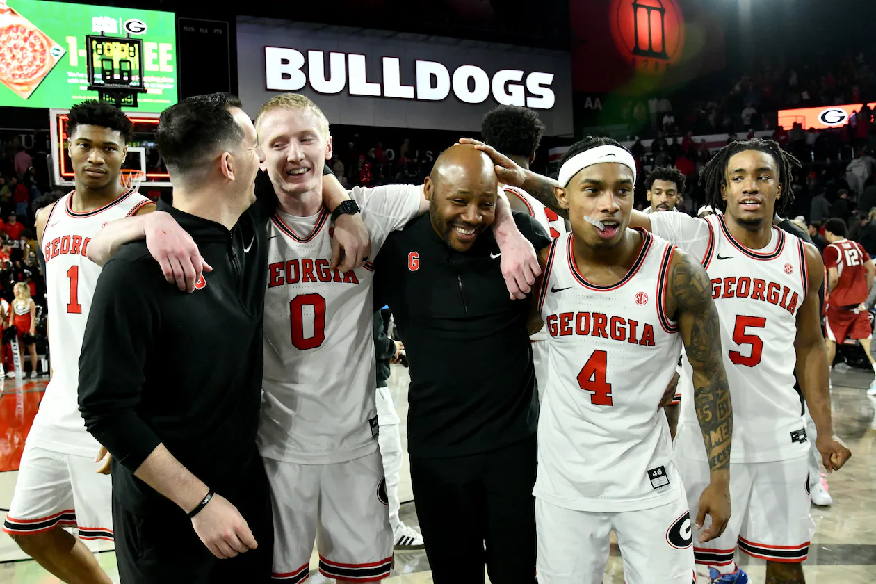 Georgia players and coaches celebrate Georgia's 90-76 win over Arkansas on Saturday, Jan. 17, 2026, at Stegeman Coliseum in Athens. (Hyosub Shin/AJC)