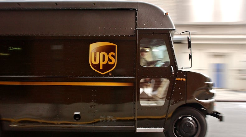 NEW YORK - DECEMBER 23: A delivery truck makes its way out of the 43rd Street United Parcel Service (UPS) depot December 23, 2003 in New York City. UPS, which averages about 13 million packages per day during the holiday season, will ship more than 300 million packages this holiday season.