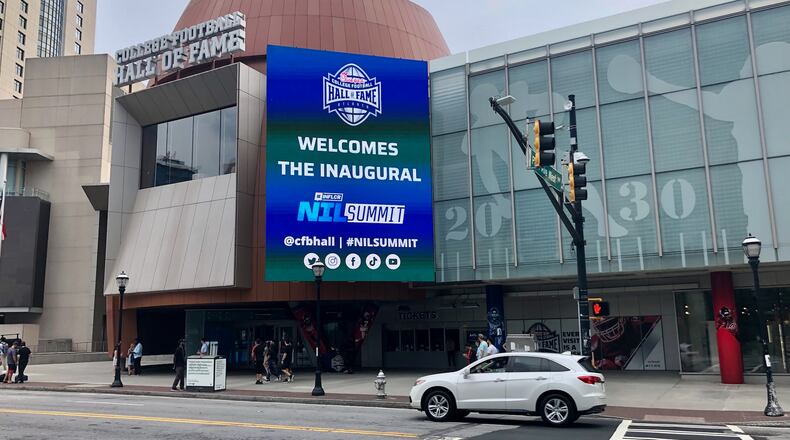 A marquee outside the College Football Hall of Fame in downtown Atlanta welcomes the first NIL Summit, held at the hall June 13-15. (AJC photo by Ken Sugiura)