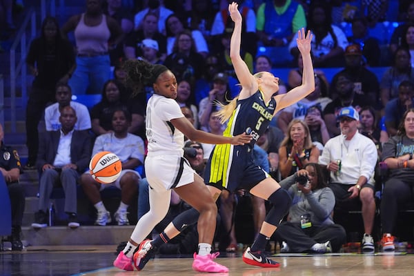 Las Vegas Aces guard Dana Evans (11) strips the ball from Dallas Wings guard Paige Bueckers (5) during the second half of a WNBA basketball game in Arlington, Texas, Wednesday, July 16, 2025. (AP Photo/LM Otero)