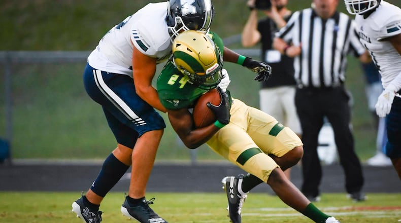 Grayson WR Darius Daniel is tackled by Marietta LB Carlos Cervante during the first half of Friday's game. (John Amis/Special)