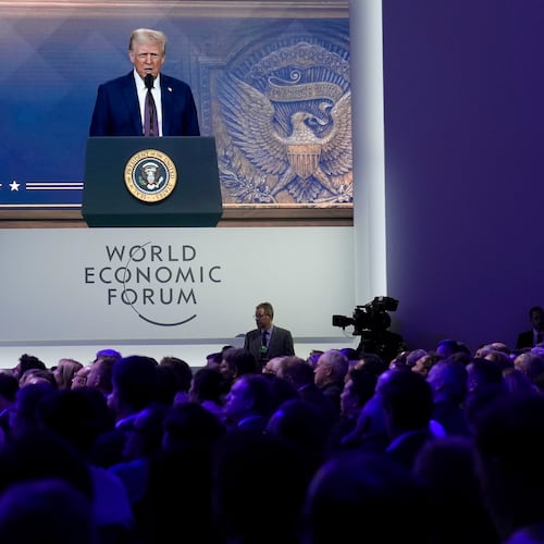 FILE - Attendees listen to a virtual speech delivered by U.S. president Donald Trump, at the Annual Meeting of World Economic Forum in Davos, Switzerland, Thursday, Jan. 23, 2025. (AP Photo/Markus Schreiber, file)