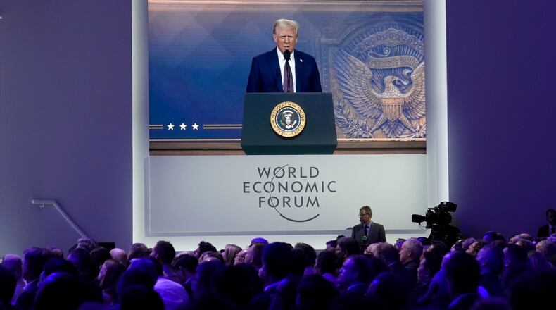 FILE - Attendees listen to a virtual speech delivered by U.S. president Donald Trump, at the Annual Meeting of World Economic Forum in Davos, Switzerland, Thursday, Jan. 23, 2025. (AP Photo/Markus Schreiber, file)