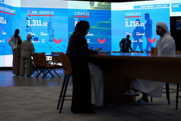 Emiratis are seen in the Dubai Financial Market in Dubai, United Arab Emirates, Monday, April 7, 2025. (AP Photos/Fatima Shbair)