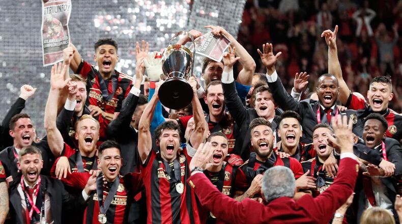 Atlanta United players celebrate winning the MLS Cup 2-0 over the Portland Timbers on Saturday, December 8, 2018, at Mercedes-Benz Stadium in Atlanta. Team owner Arthur Blank is in the foreground. (Photo: BOB ANDRES / BANDRES@AJC.COM)