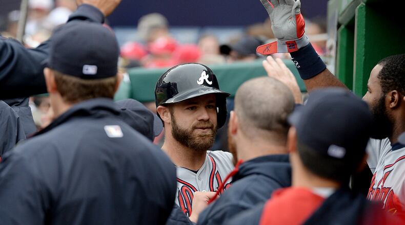 Atlanta Braves catcher Evan Gattis (24), center, is congratulated in the dugout following his solo home run against the Washington Nationals in the fifth inning at Nationals Park in Washington, D.C., Friday, April 4, 2014. The Braves defeated the Nationals, 2-1. (Chuck Myers/MCT)