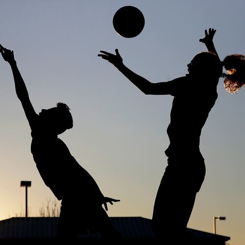 FILE - Friends practice volleyball at a local park in Gilbert, Ariz., March 15, 2020. (AP Photo/Matt York, File)
