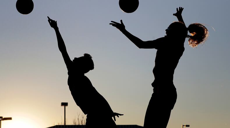 FILE - Friends practice volleyball at a local park in Gilbert, Ariz., March 15, 2020. (AP Photo/Matt York, File)