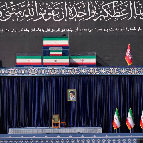 The coffins of slain Iranian Supreme Leader Ayatollah Ali Khamenei and members of his family are displayed on a platform above an empty chair at the start of the dayslong funeral ceremonies at the Imam Khomeini Mosalla Grand Mosque in Tehran, Iran, Saturday, July 4, 2026. (AP Photo/Altaf Qadri)