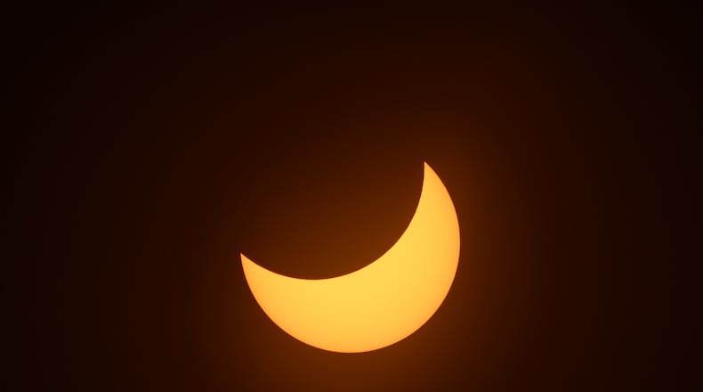 The moon gradually occludes the sun during a total solar eclipse, seen from Exmouth, Australia, on Thursday, April 20, 2023. A solar eclipse will be visible in North America in April 2024. The Atlanta area will likely be able to see a partial eclipse. (Matthew Abbott/The New York Times)
