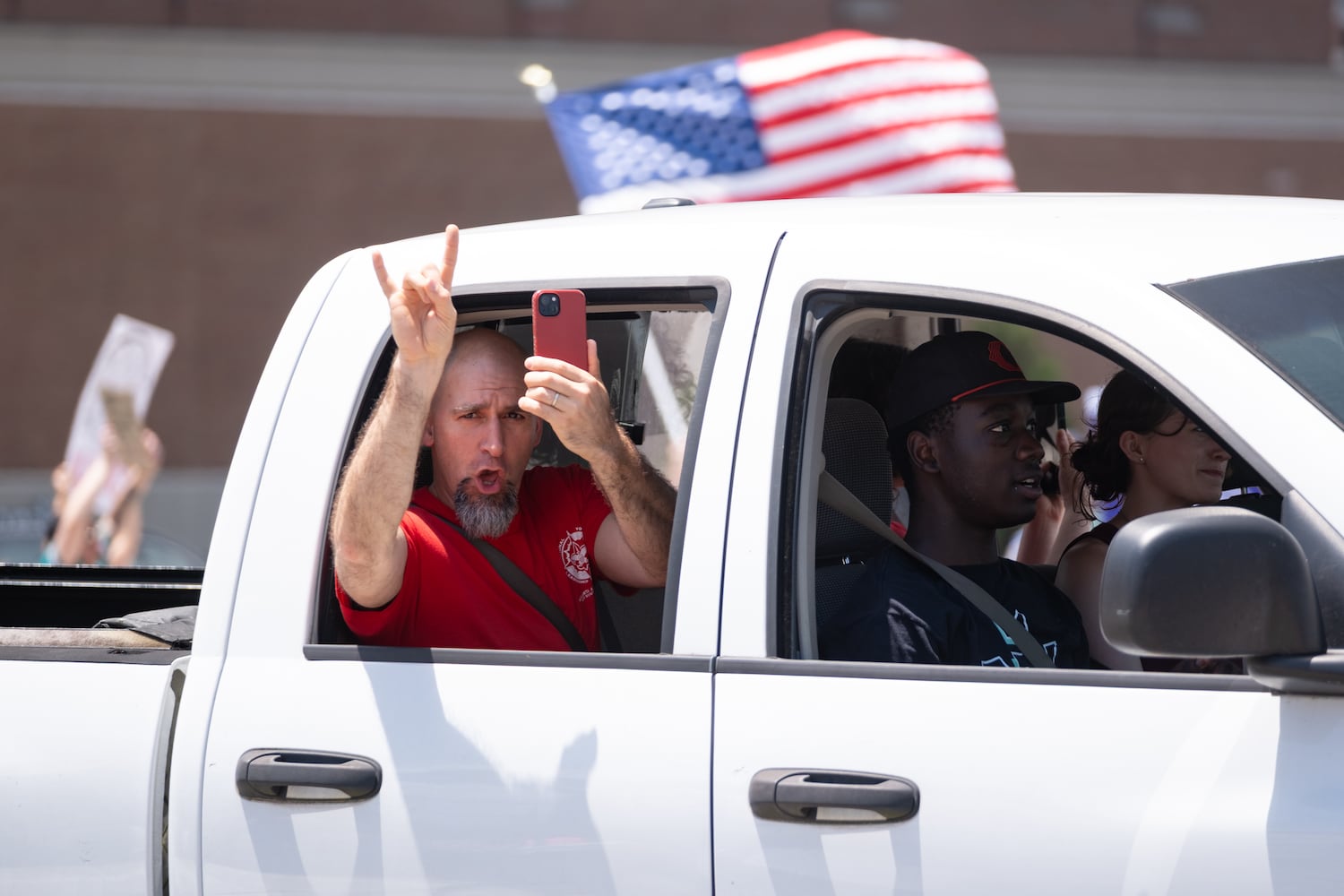 A supporter drives across the 17th Street bridge in Atlanta while people protest as part of the nation-wide No Kings protests Saturday, June 14, 2025.   Ben Gray for the Atlanta Journal-Constitution